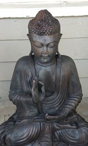 Hand carved mahogany buddha. Deeply charred wood.